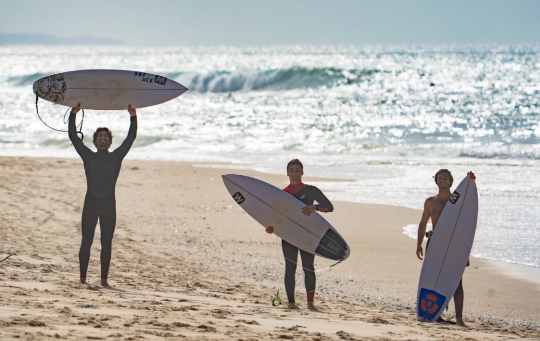 Watta riders on the beach with their boards
